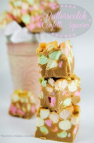 These three confetti squares are piled high on top of each other, looking all delicious and yummy! The little grey and pink logo above the squares says Butterscotch Confetti Squares". 