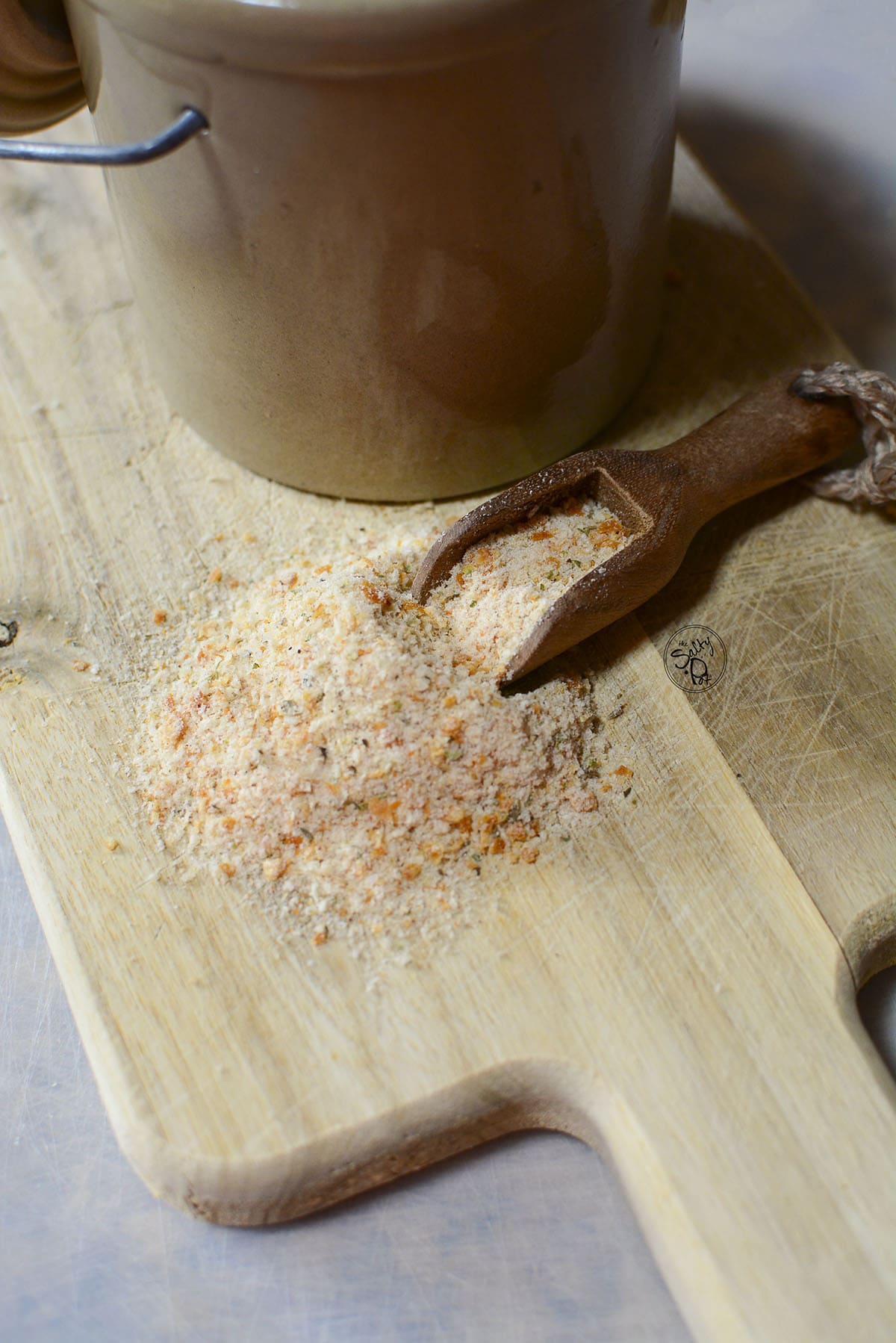 Seasoned breadcrumbs on a cutting board.
