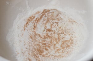 Flour in a bowl with yeast sprinkled over the top