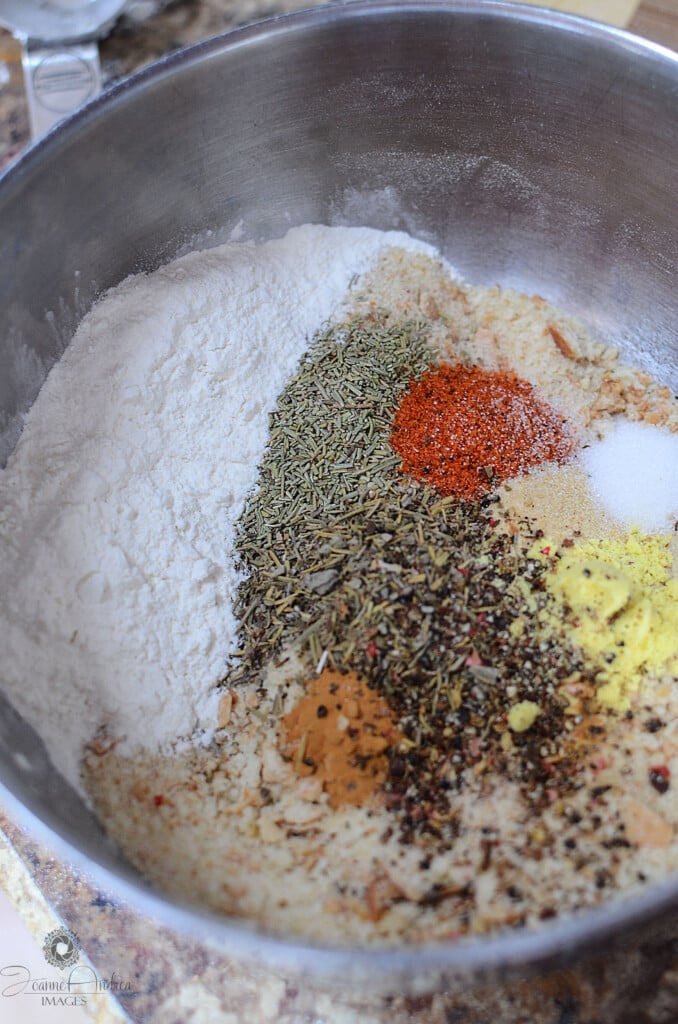 Breadcrumbs and spices arranged in a metal bowl.