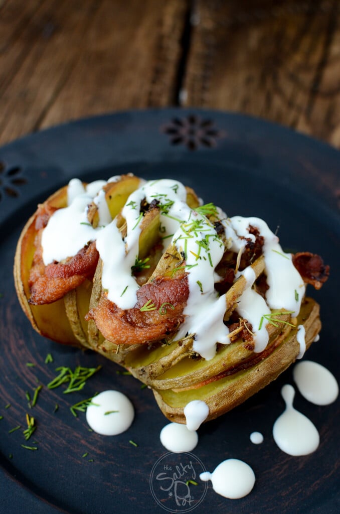 Smoky Bacon with a cream sauce drizzled on top of a hasselback potato.