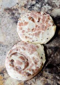 Two raw cinnamon buns put close together, waiting to be rolled out.