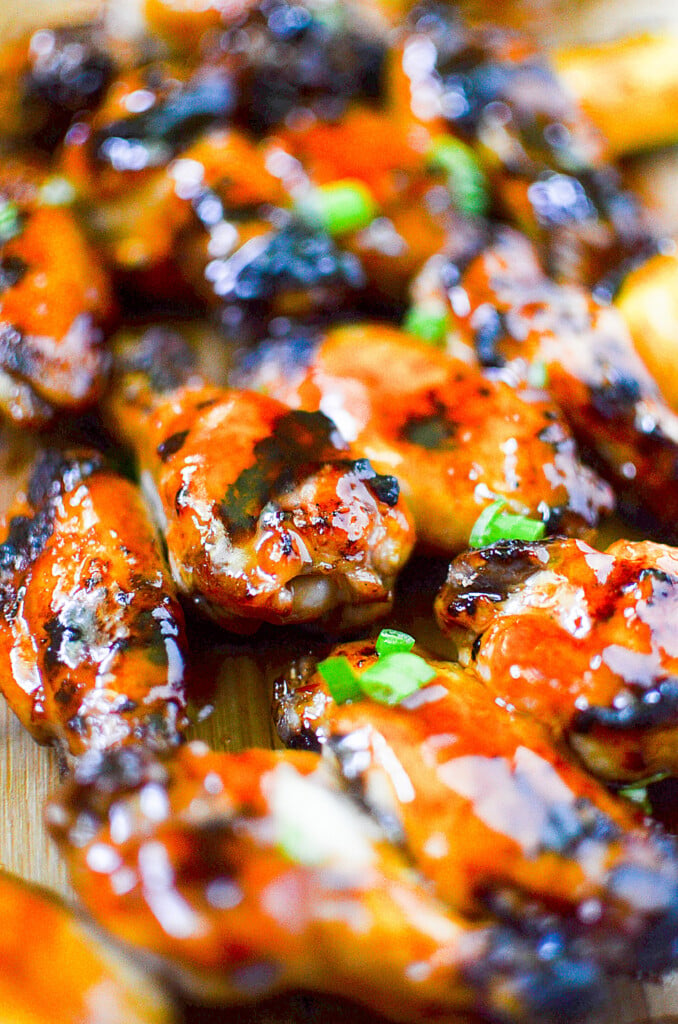 Showing the chicken wings glazed and sprinkled with green onions after they are grilled.