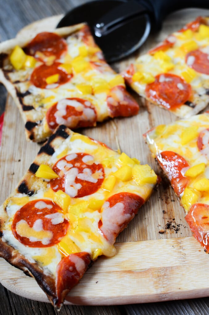 30 best camping meals ever! Pepperoni pizza on a cutting board fresh off the grill!