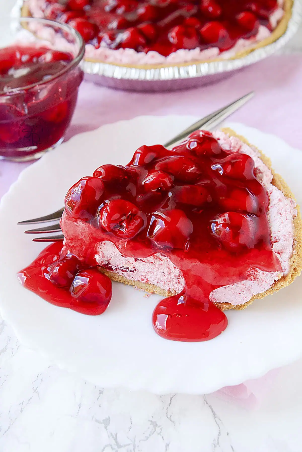 A slice of cherry fluff pie on a white plate.