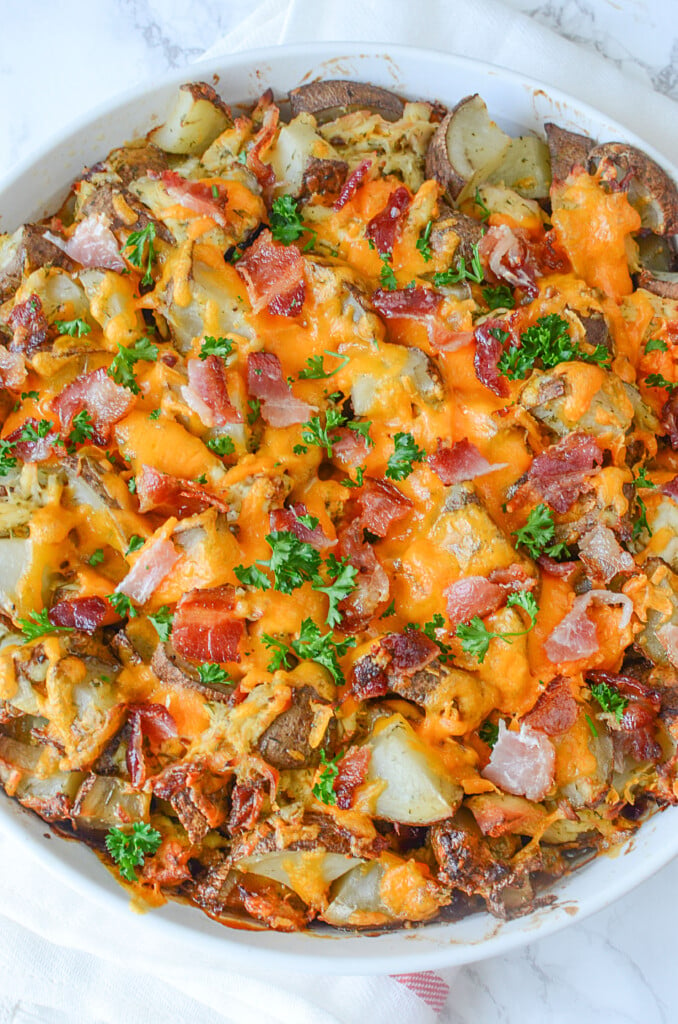 A super pretty top down photo of this dish. The melted cheese and bacon pieces all mixed in with the cooked potatoes look delicious in the white baking dish.