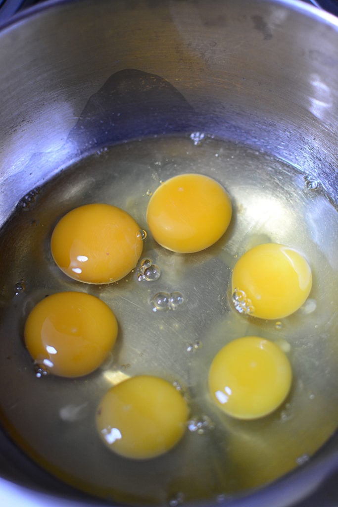 6 eggs in a stainless steel bowl.