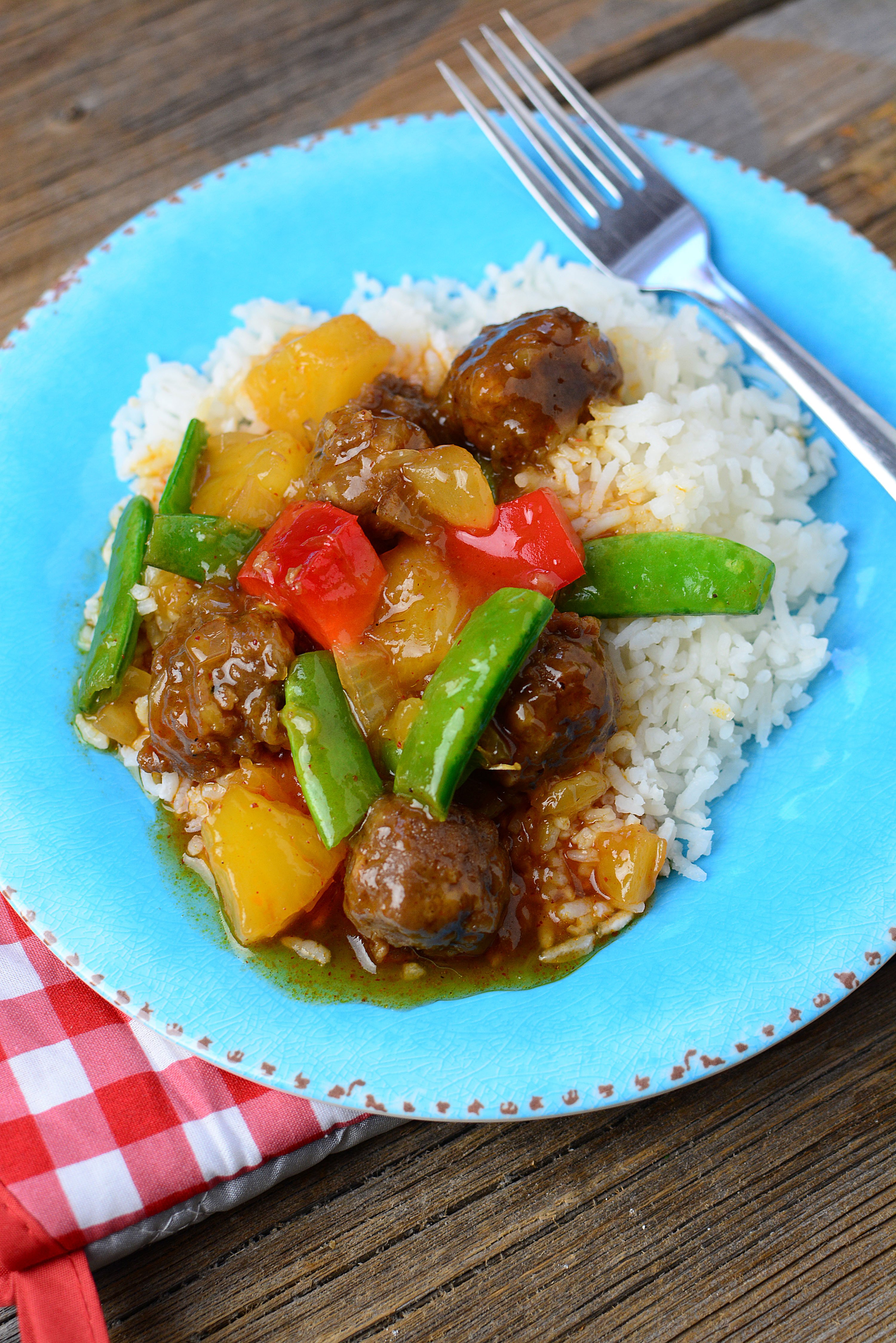 Slow cooker pineapple bbq meatballs recipe on a blue plate. 