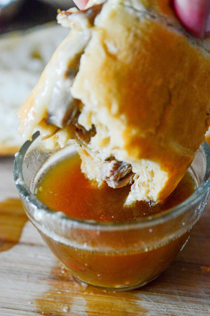 This Instant Pot Mississippi Pulled Pork Dip is a twist on the classic Mississippi Pot Roast, traditionally done with beef, is made super quick in the Instant Pot with a pork roast instead!! Shredded pulled pork made delicious into a bun, with cheese, and dipping au jus or juice. It's the perfect sandwich!!