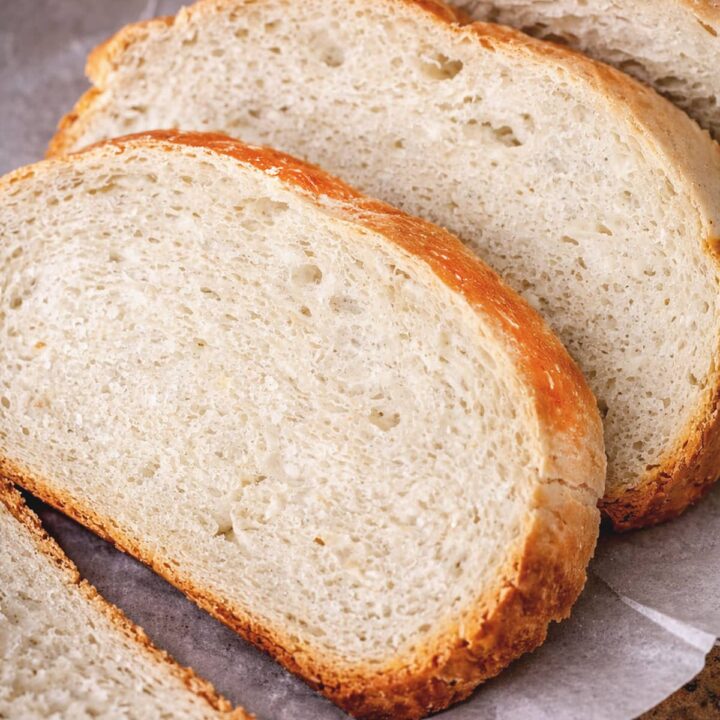 Slow cooker bread sliced in white parchment paper.