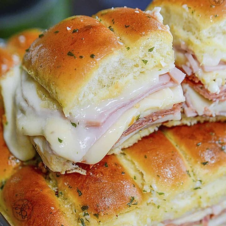 One italian slider resting on top of the other ones in a pan.