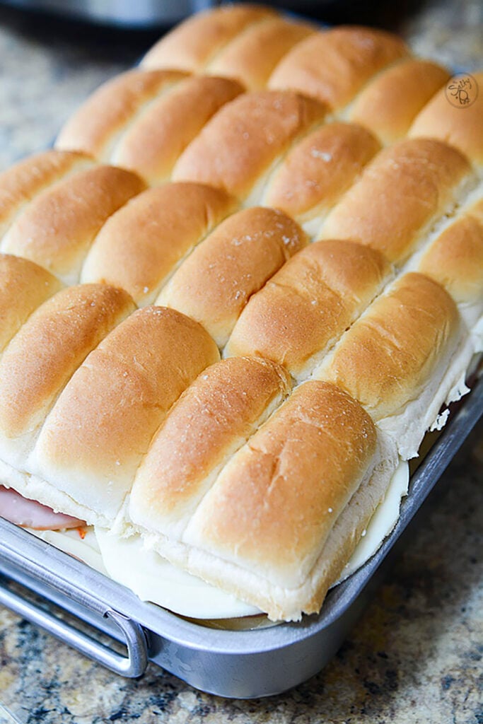 The top portion of the tray buns on top of the other ingredients.