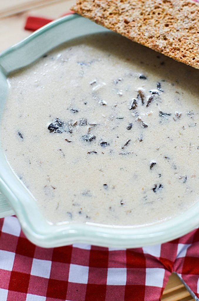 This hearty home made mushroom soup is made in the slow cooker to develop flavors and cater to convenience. But looking at this delicious soup in the bowl with the cracker, there's no questioning it that cooking it in the slow cooker is the way to go!