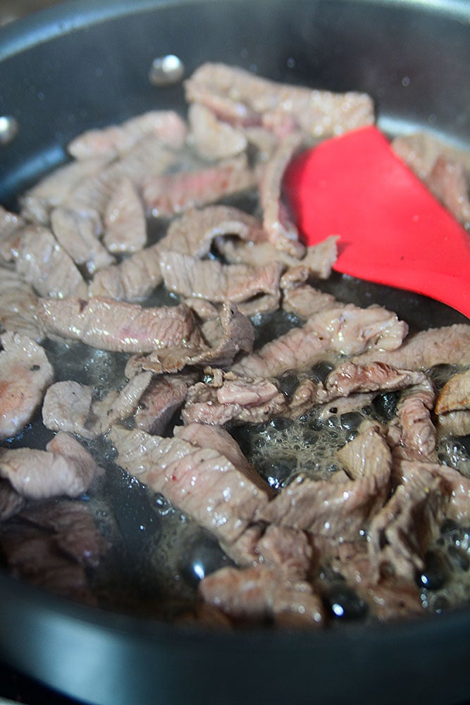 Easy skillet beef and broccoli ramen. These slices of beef sauteing in the pan is the second step to making this delicious one pan beef and broccoli ramen stirfry! 