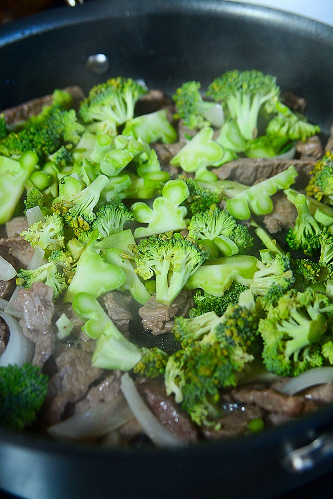 Easy skillet beef and broccoli ramen. These gorgeous fresh and green broccoli florets being added to the pan of sizzling beef strips is the third step to making this delicious super simple beef and broccoli ramen stirfry! 