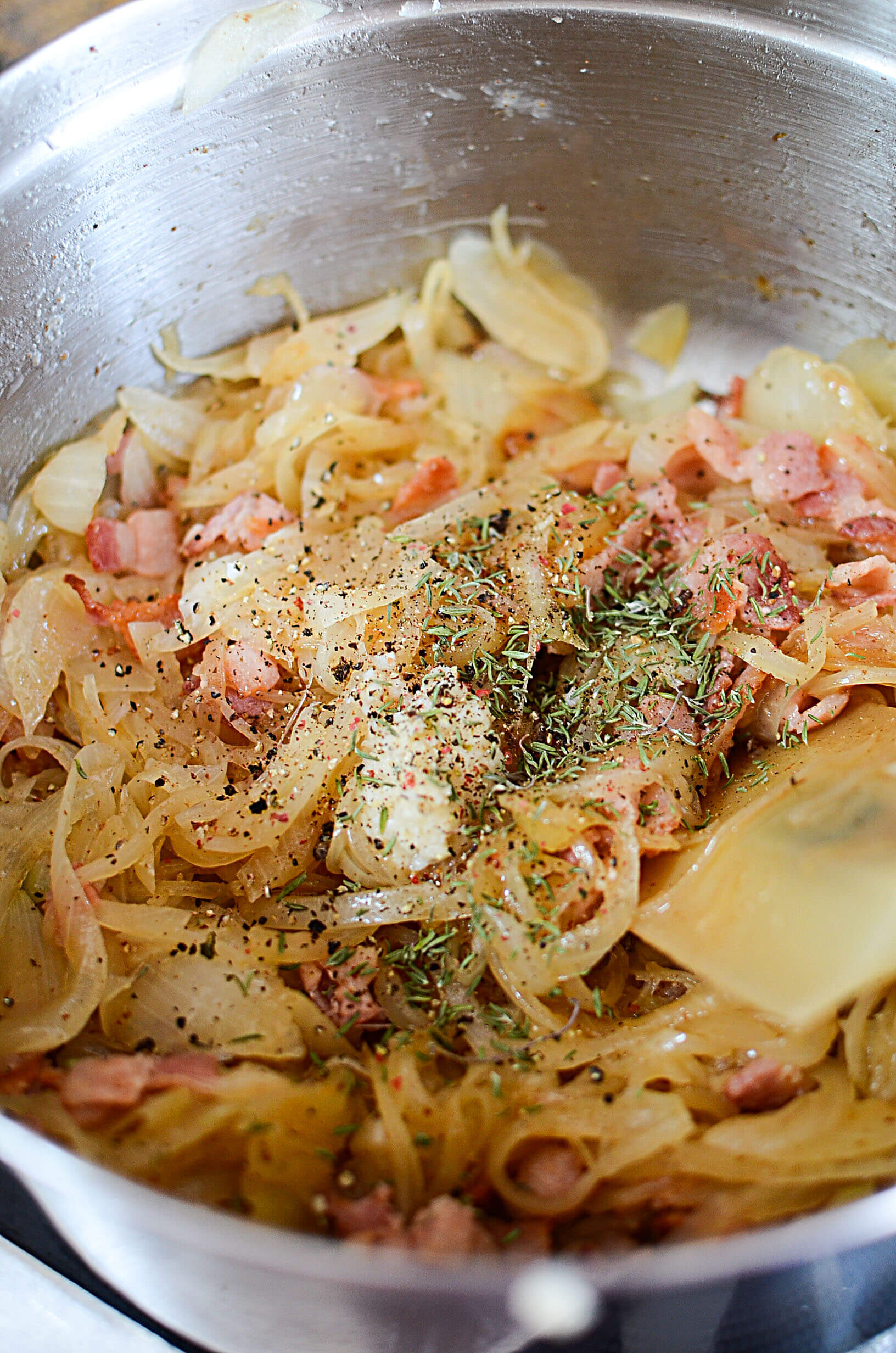 Dried thyme and other spices are added on top of the onions.