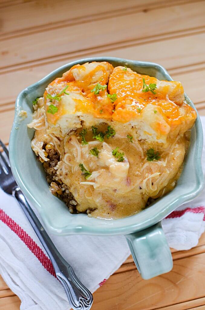 Slow cooker comfort food at it's finest! Slow cooker cheesy chicken and biscuits has creamy cheese sauce, juicy chicken topped with soft biscuits, all done in the slow cooker! This crock pot cheesy chicken and biscuits dish will be one in your regular rotation - it's so easy, using ingredients right from your pantry!