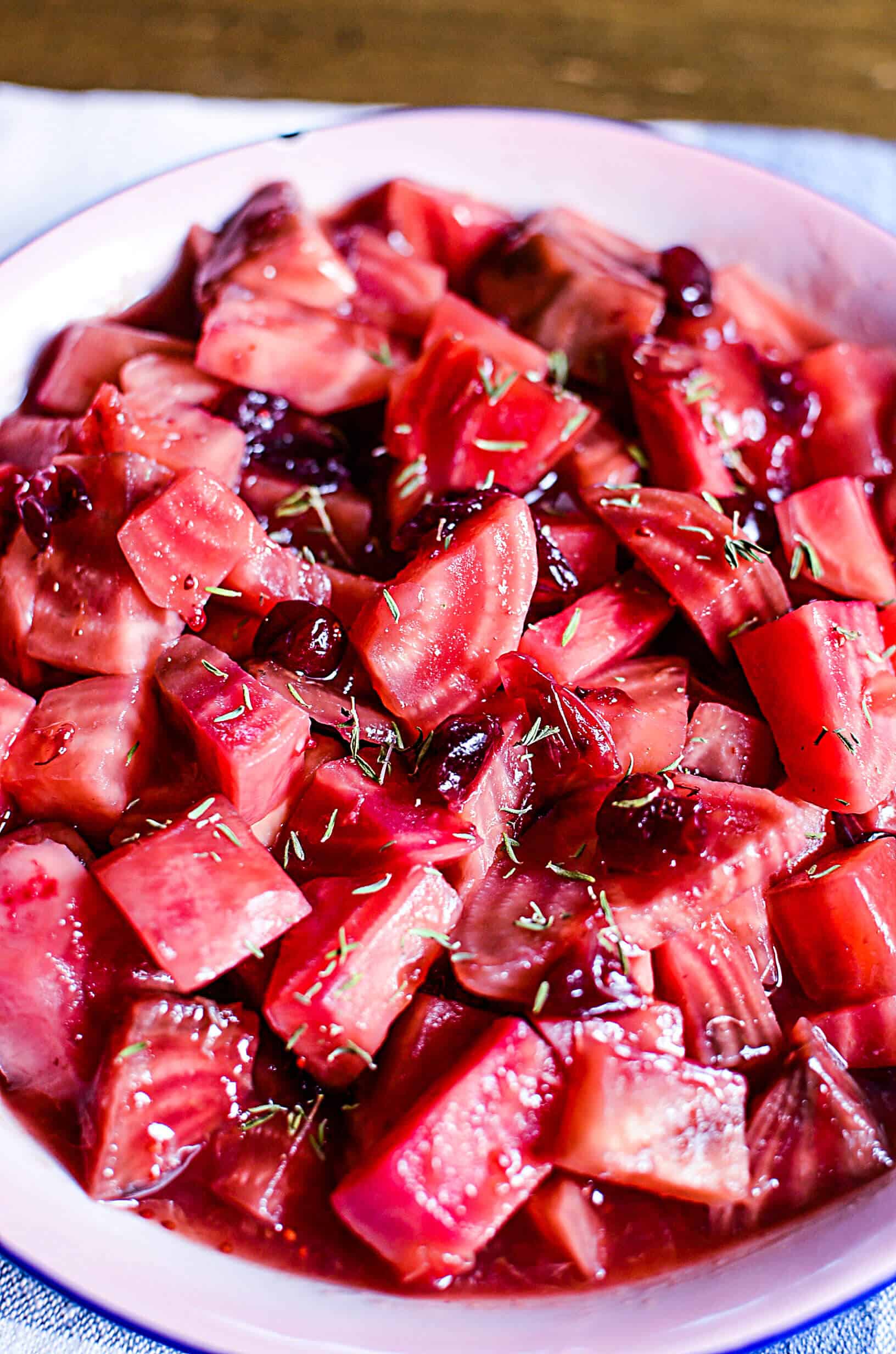 Cooked candycane beets with cranberries in a serving bowl perfect for any festive holiday table.