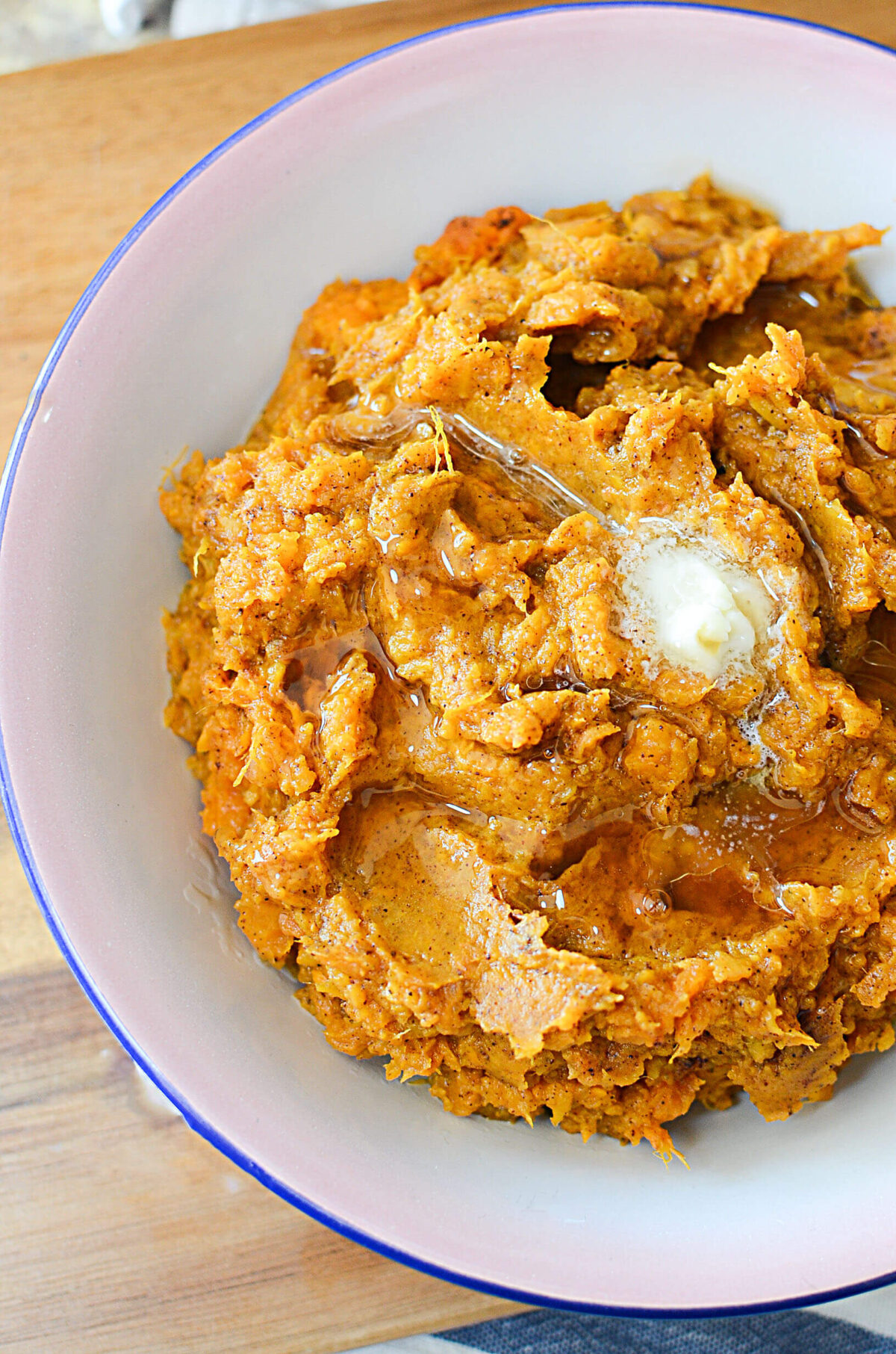 A photo of half the bowl of mashed sweet potatoes with maple butter