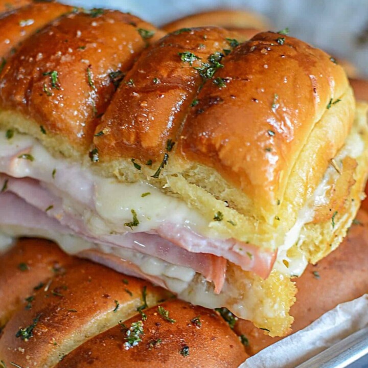 Chicken cordon bleu sliders resting on top of more sliders, fresh from the oven.