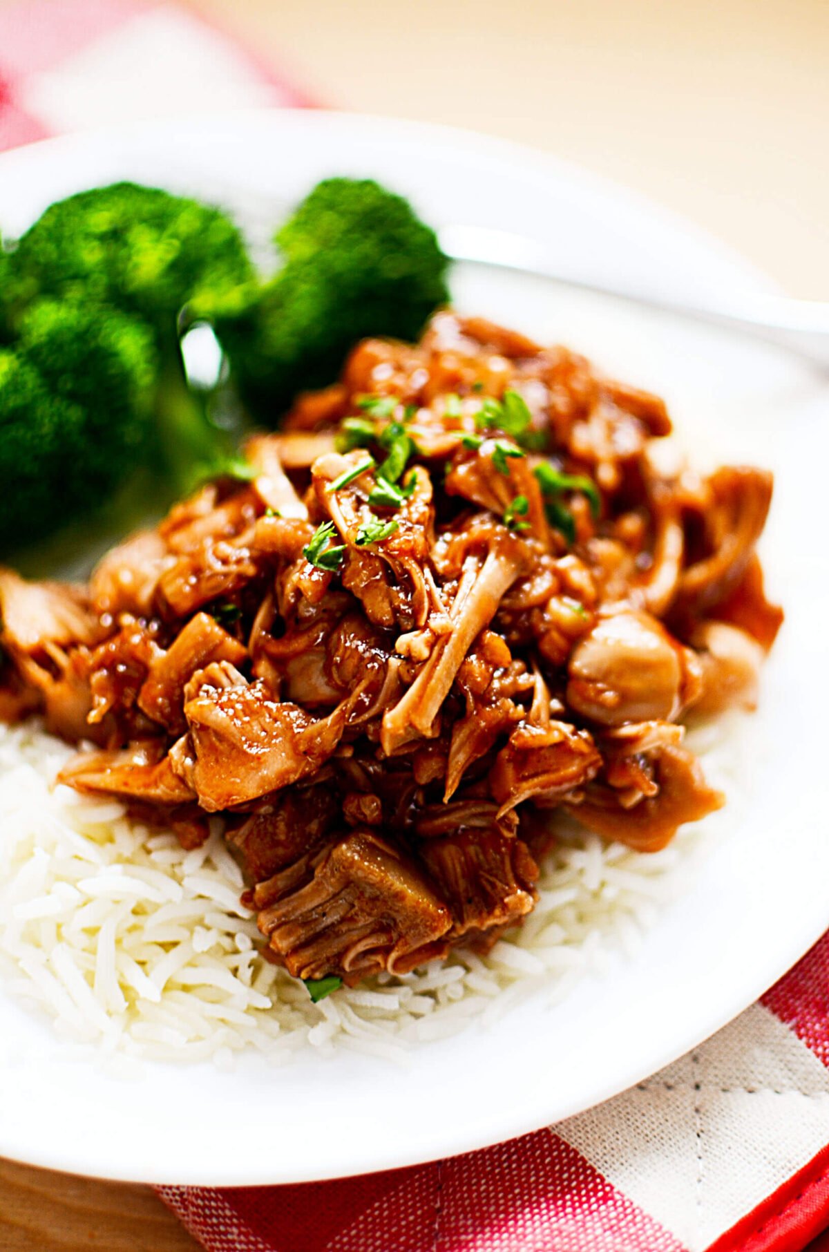 Vegetarian pulled pork served with rice and broccoli on the side.