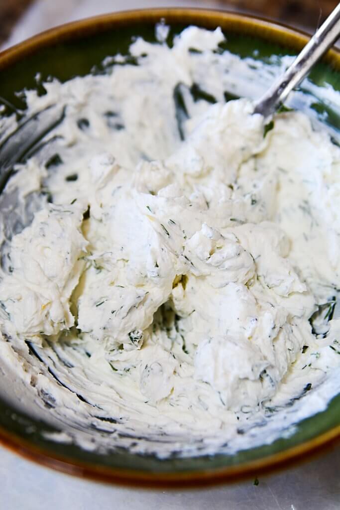Mixed and spreadable lemon and dill cream cheese.