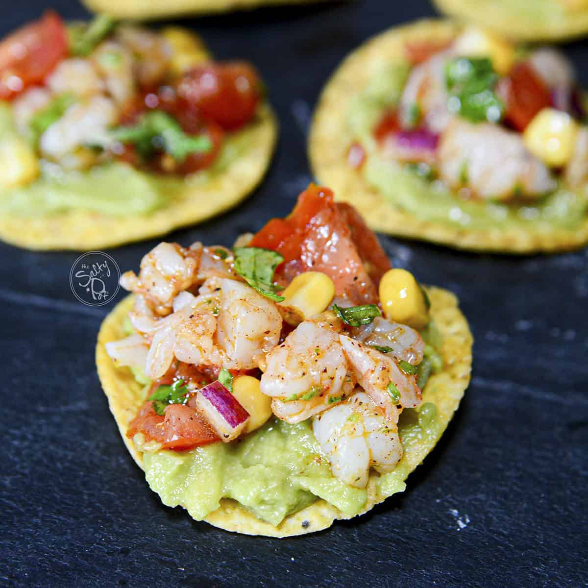 Shrimp and avocado tortillas grouped together. 3 are in the photo.
