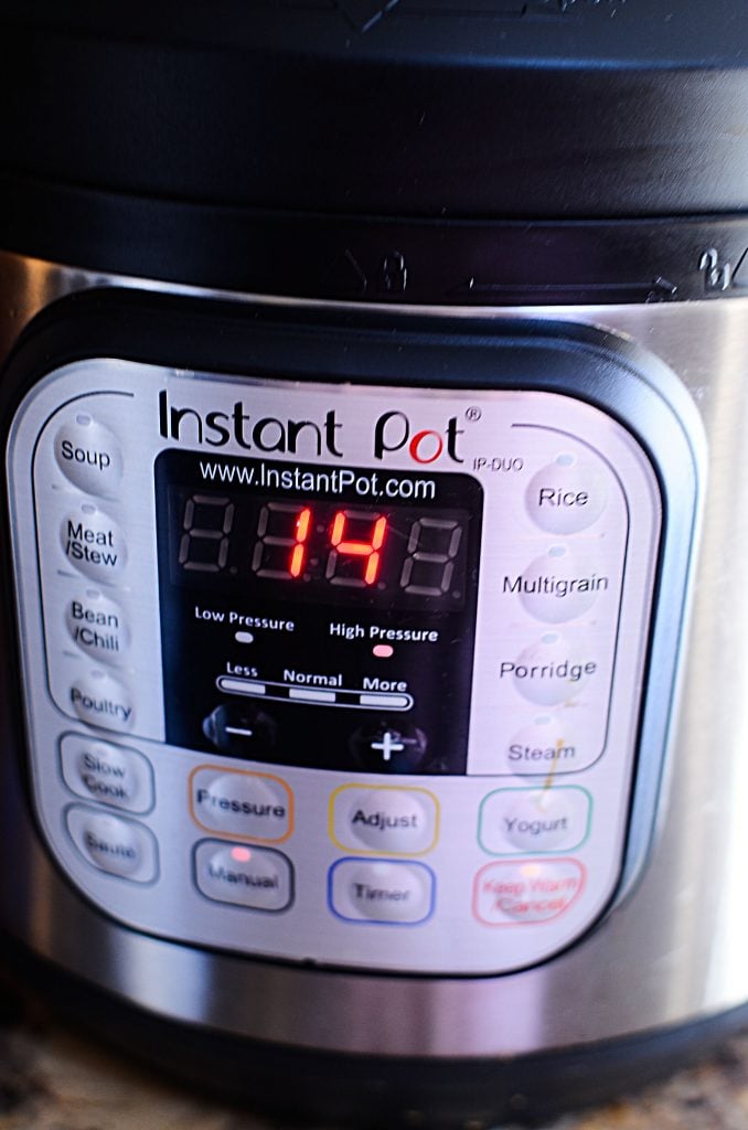 A picture of an instant pot where the adjustment buttons are shown. The number 14 in red is shown. 