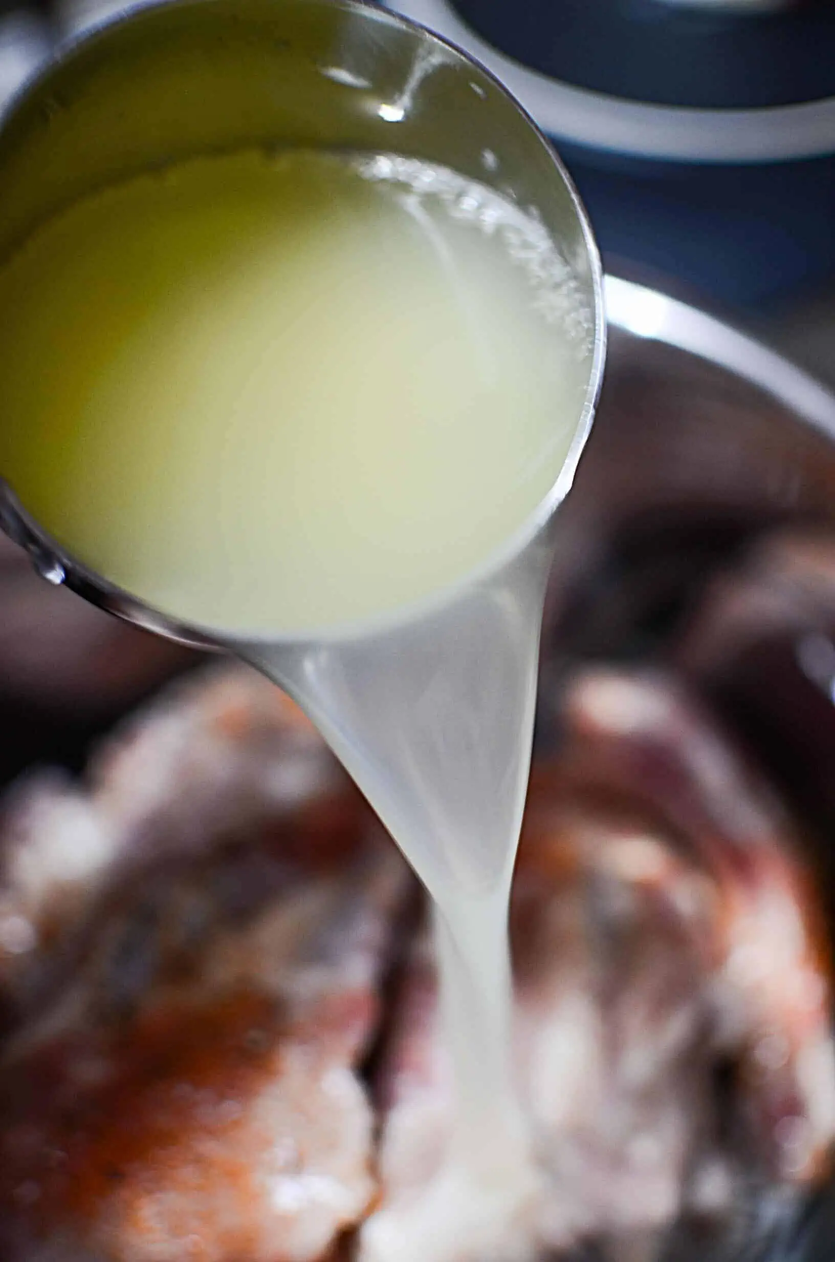 Liquid pouring into instant pot on ribs.