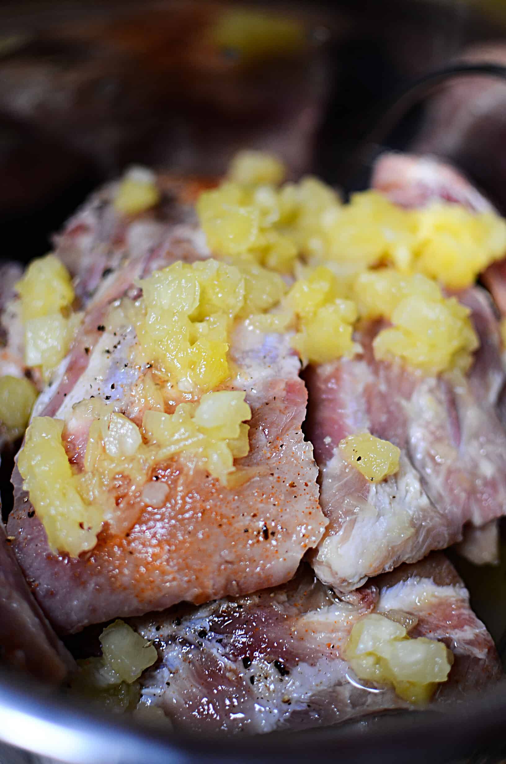 Pineapple on top of the uncooked ribs.
