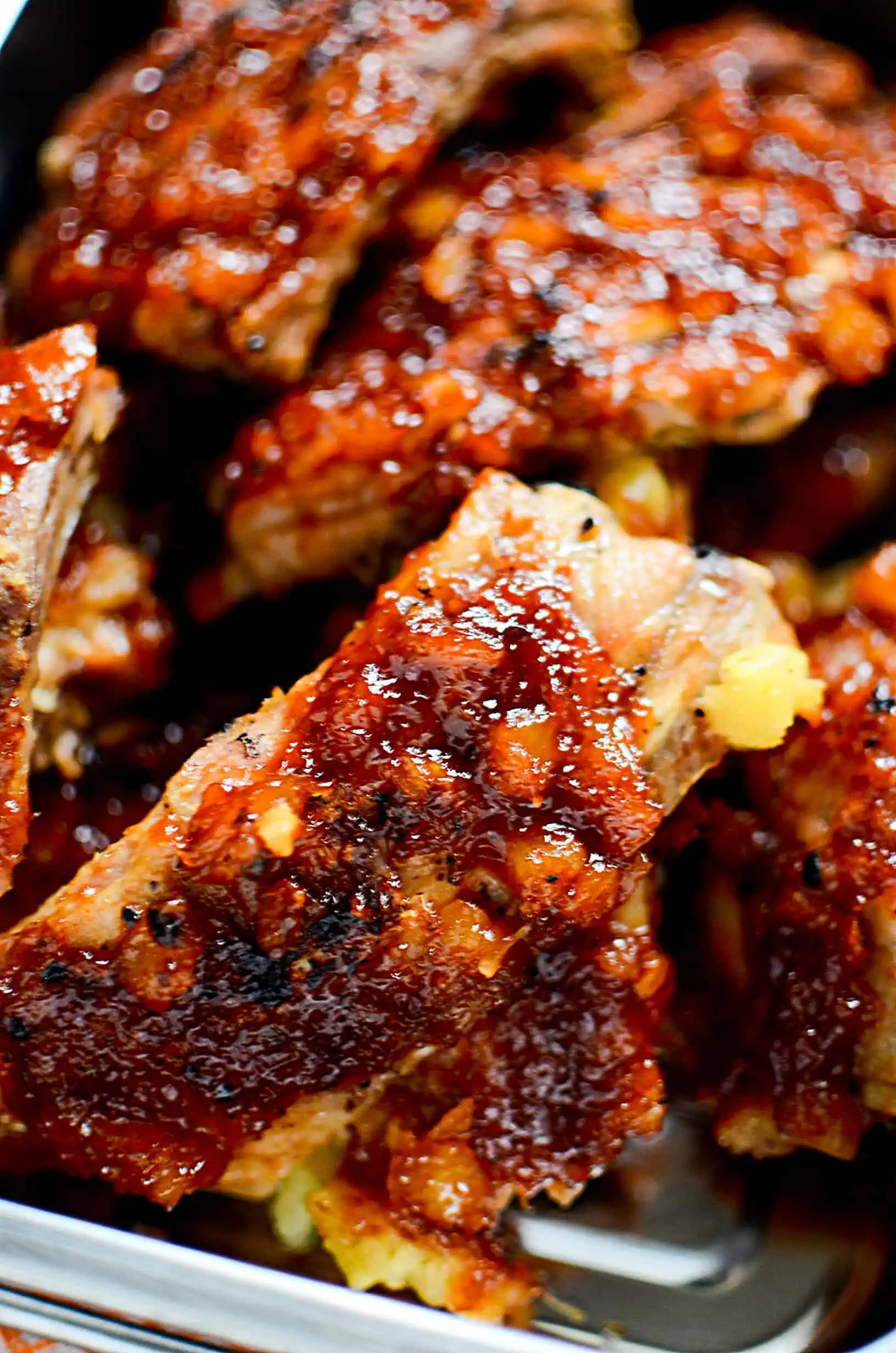 Pineapple BBQ Instant Pot Ribs  piled in a baking dish.