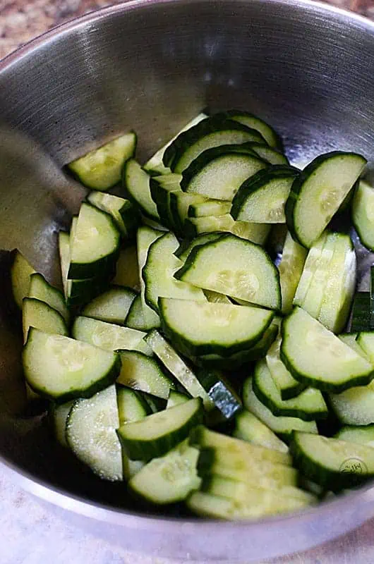 a bowl full of cucumbers sliced