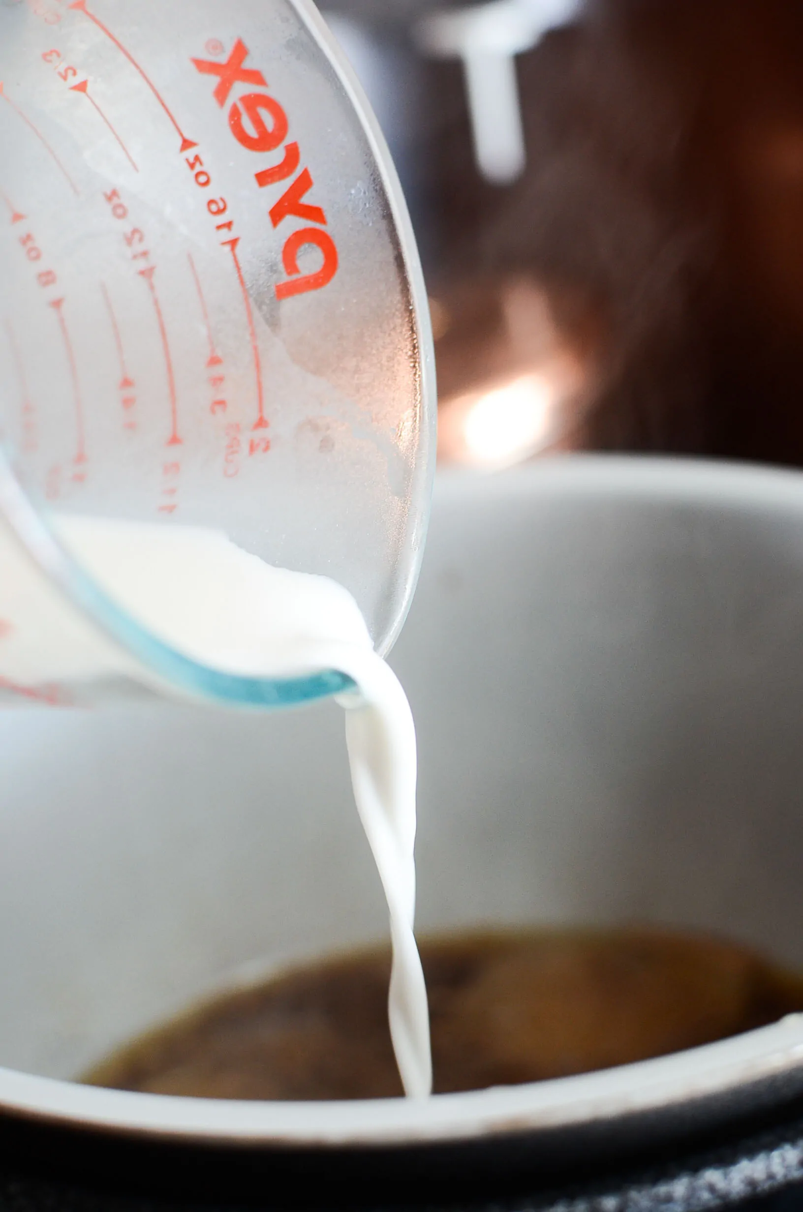 Cornstarch slurry being poured into the ninja foodi bowl to thicken into gravy