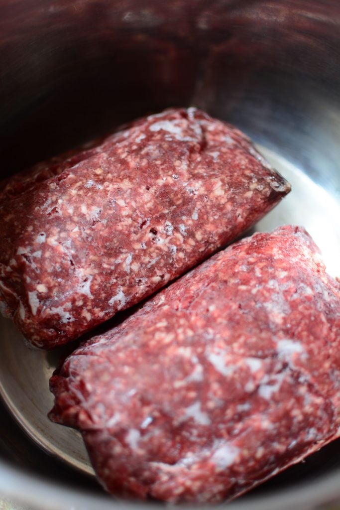 To big old lumps of frozen beef sitting in the instant pot bowl ready to be cooked!