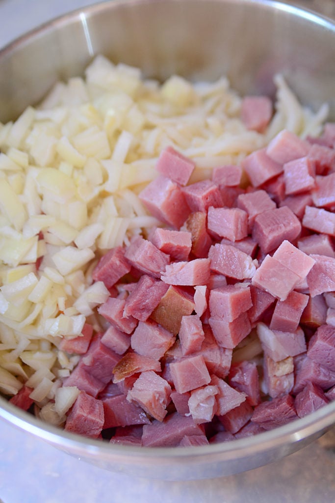 ham, potatoes and spices in a bowl, ready to be made into a this leftover ham casserole