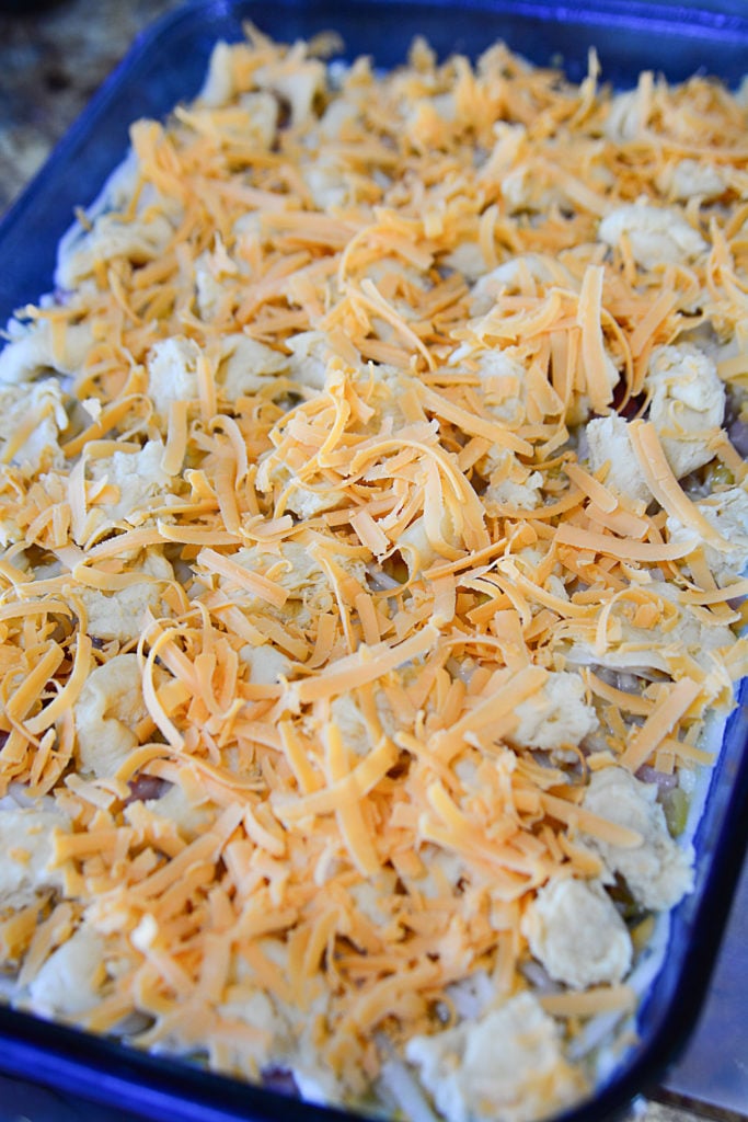 Hashbrowns, ham, corn, eggs, and cheese ready to be baked into a hashbrown casserole