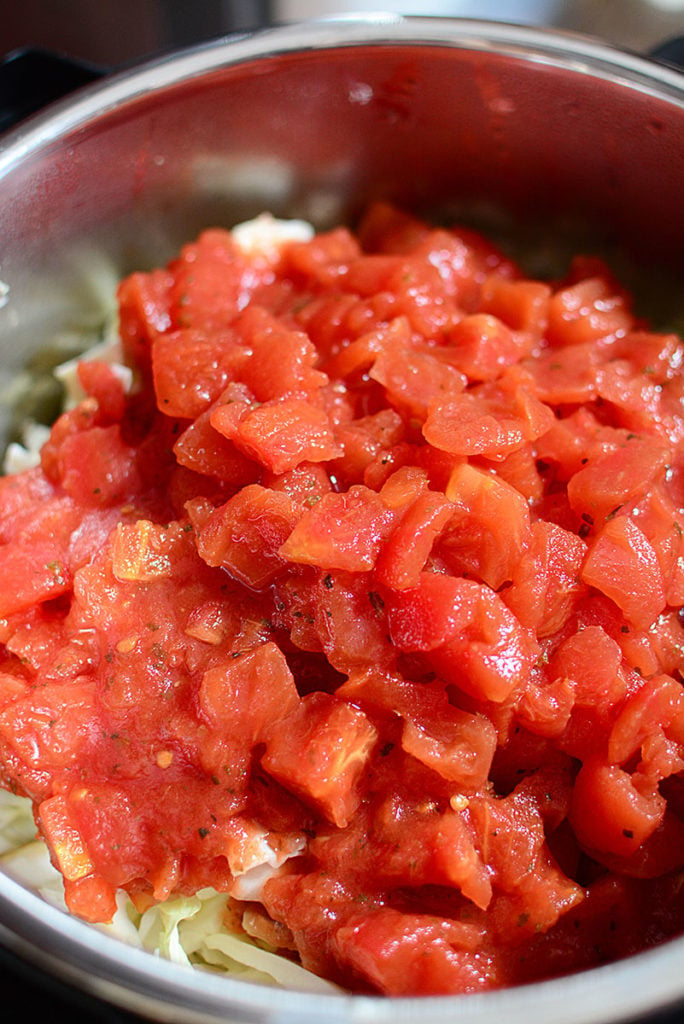 cabbage and tomato on top of the rest of the filling for the lazy cabbage rolls