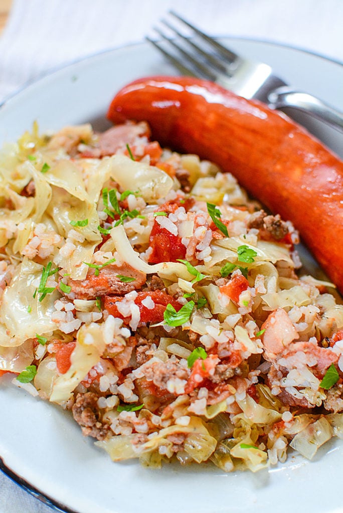 a close up of easy cabbage rolls with sausage and a fork beside it