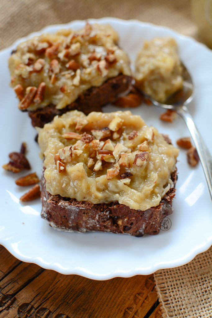two pieces of chocolate scone spread with and instant pot banana butter with pecans on top