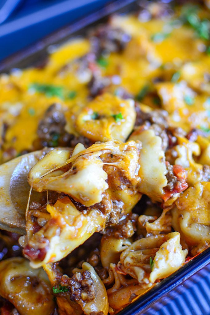 A spoon lifting out a portion of the casserole.