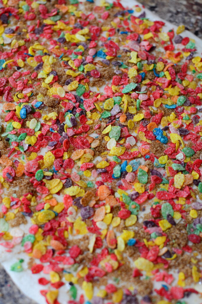 Sprinkled pebbles cereal on dough.