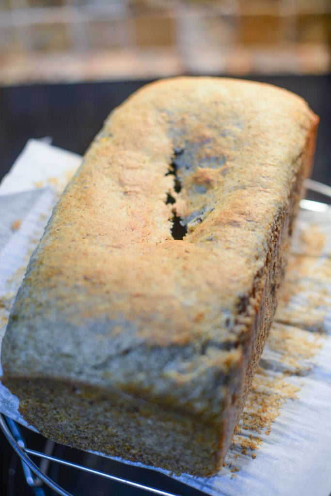 a banana loaf fresh from oven with the center having a crack