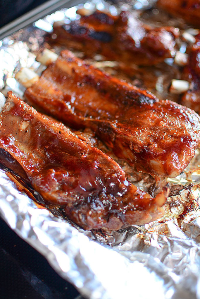 4 pieces of roasted ribs laid out on a foil.