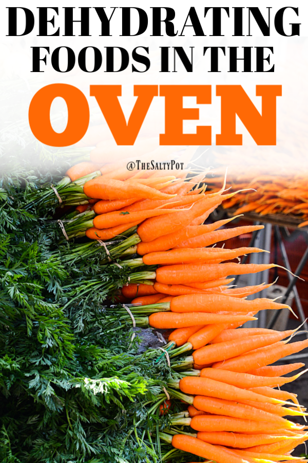 A huge stack of fresh carrots on a wooden table.