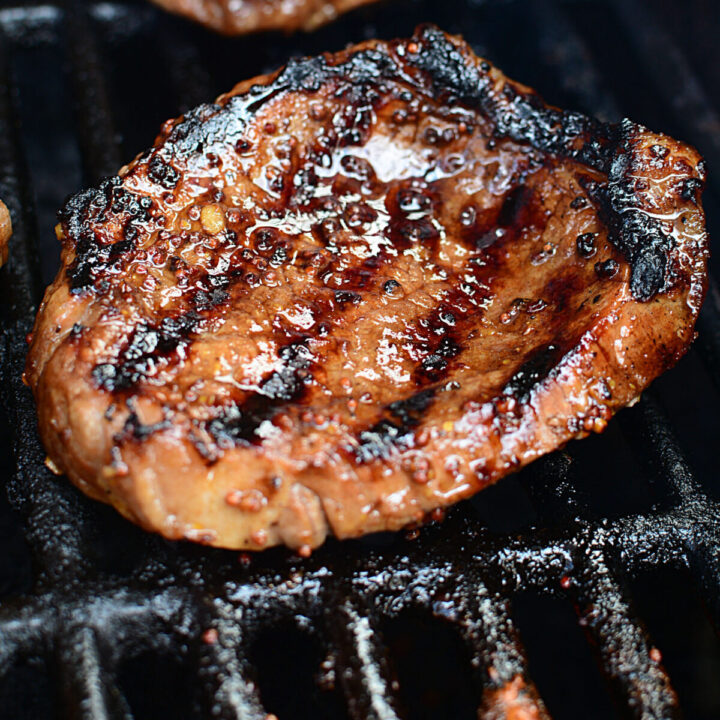 A cooked steak on the grill.