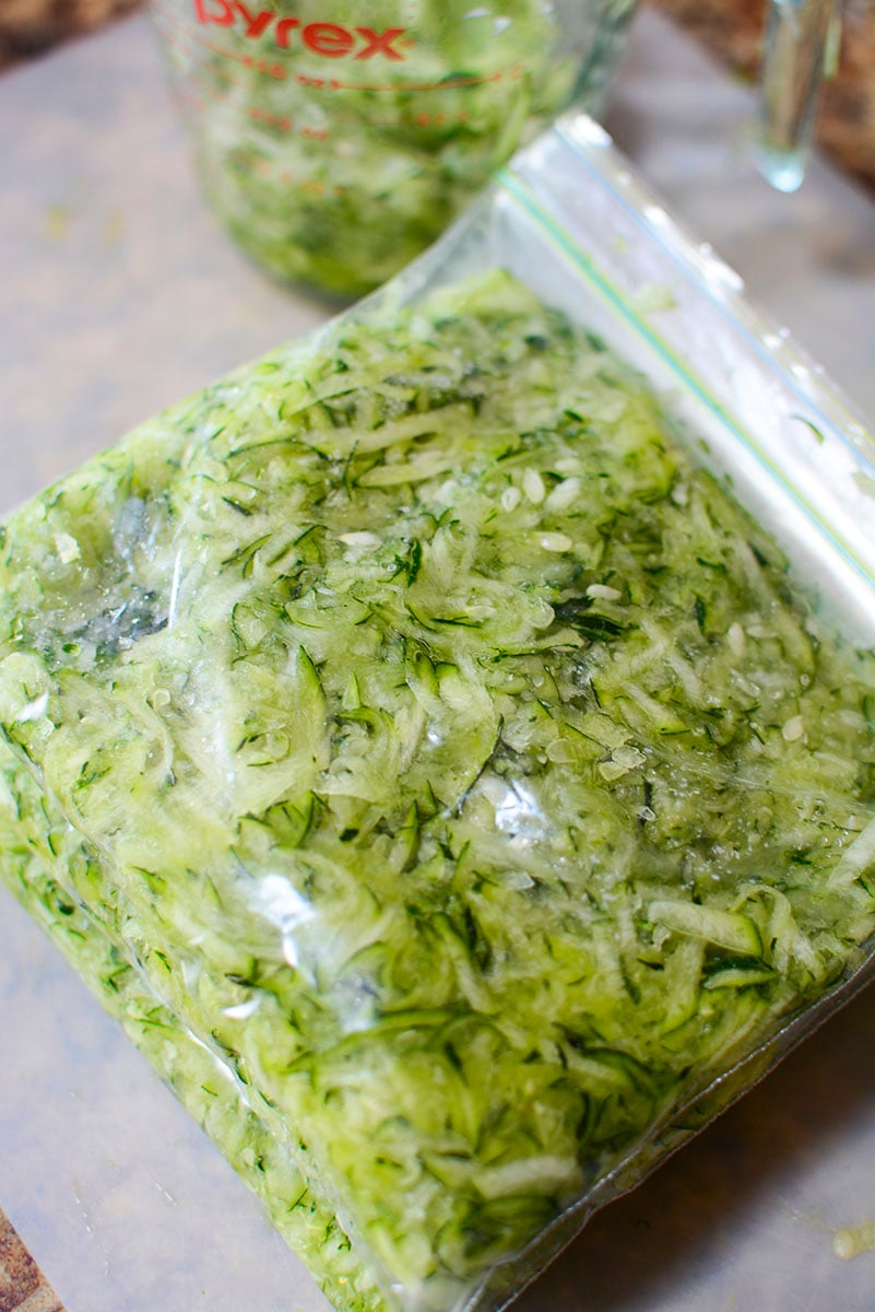 Bags of shredded zucchini piled on top of eachother ready for freezing.