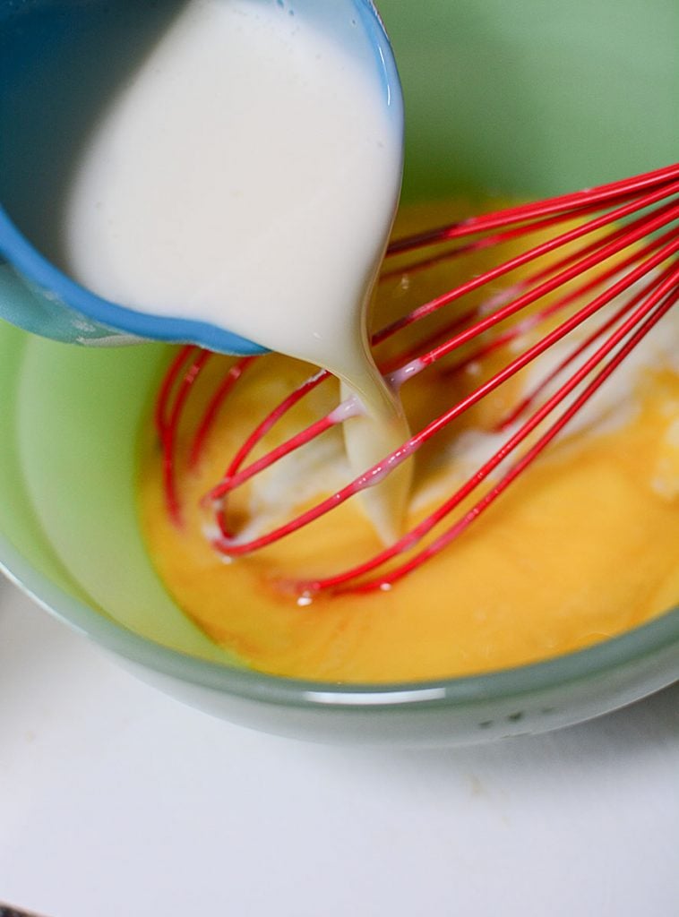 Pouring the buttermilk into the eggs to get to whiskin'! This is the wet ingredient portion of the recipe.