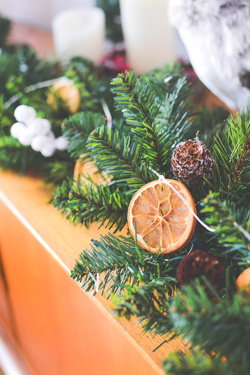 Pretty dried oranges on a string weaved in between a green garland - This sings Christmas!