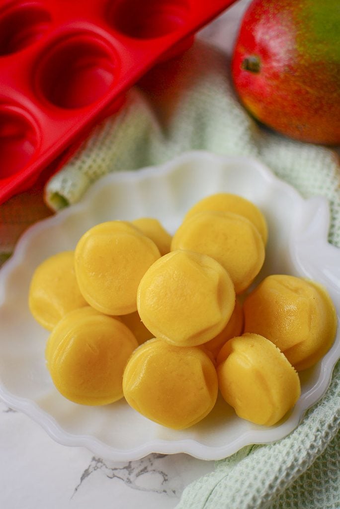 12 perfect healthy gummy treats sitting on a scalloped white plate. These gummies are so delicious!