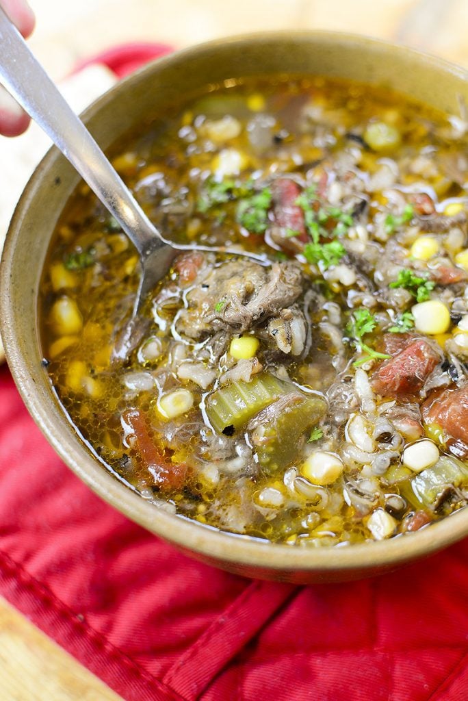 A hearty, filling delicious soup with a spoon in it, ready to be eaten!